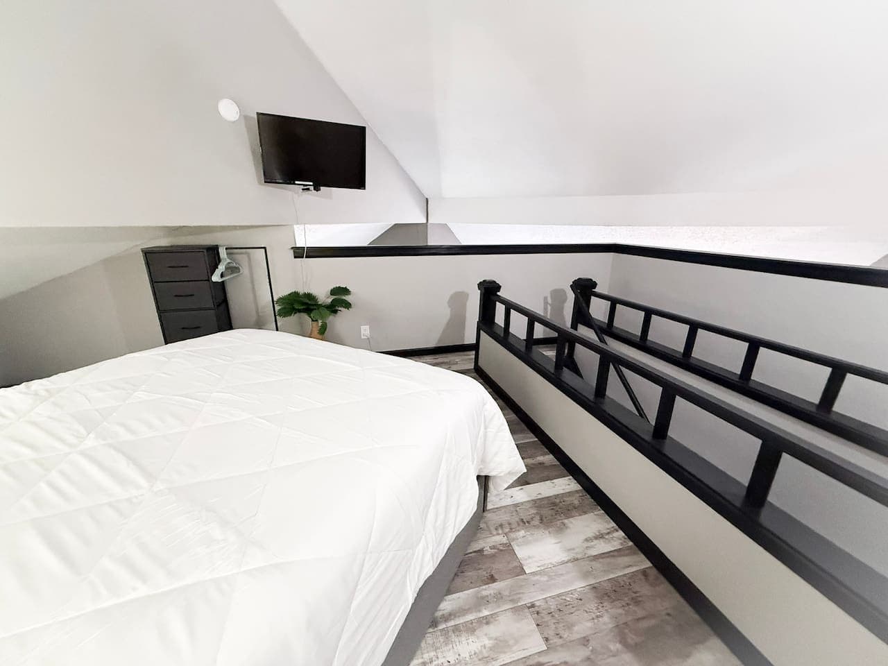 Comfortable queen bed with fresh linens and modern touches.