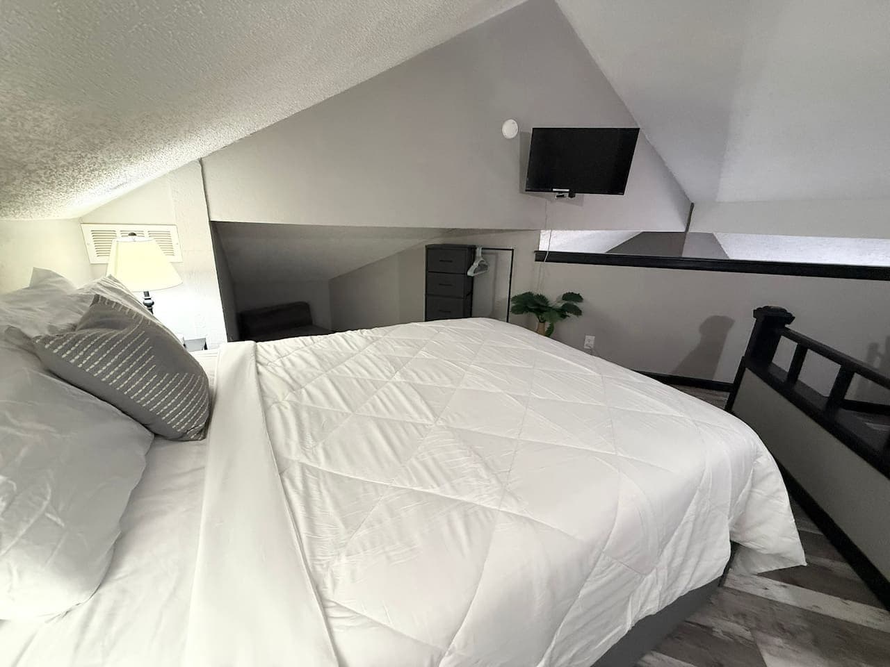 Bright loft space with comfy bedding and modern décor.