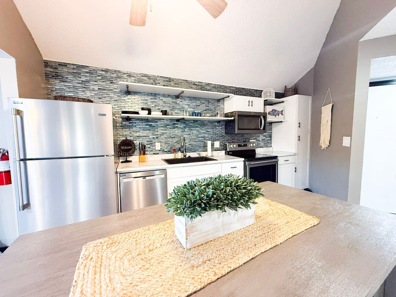 Inviting kitchen space with modern accents and warm tones.