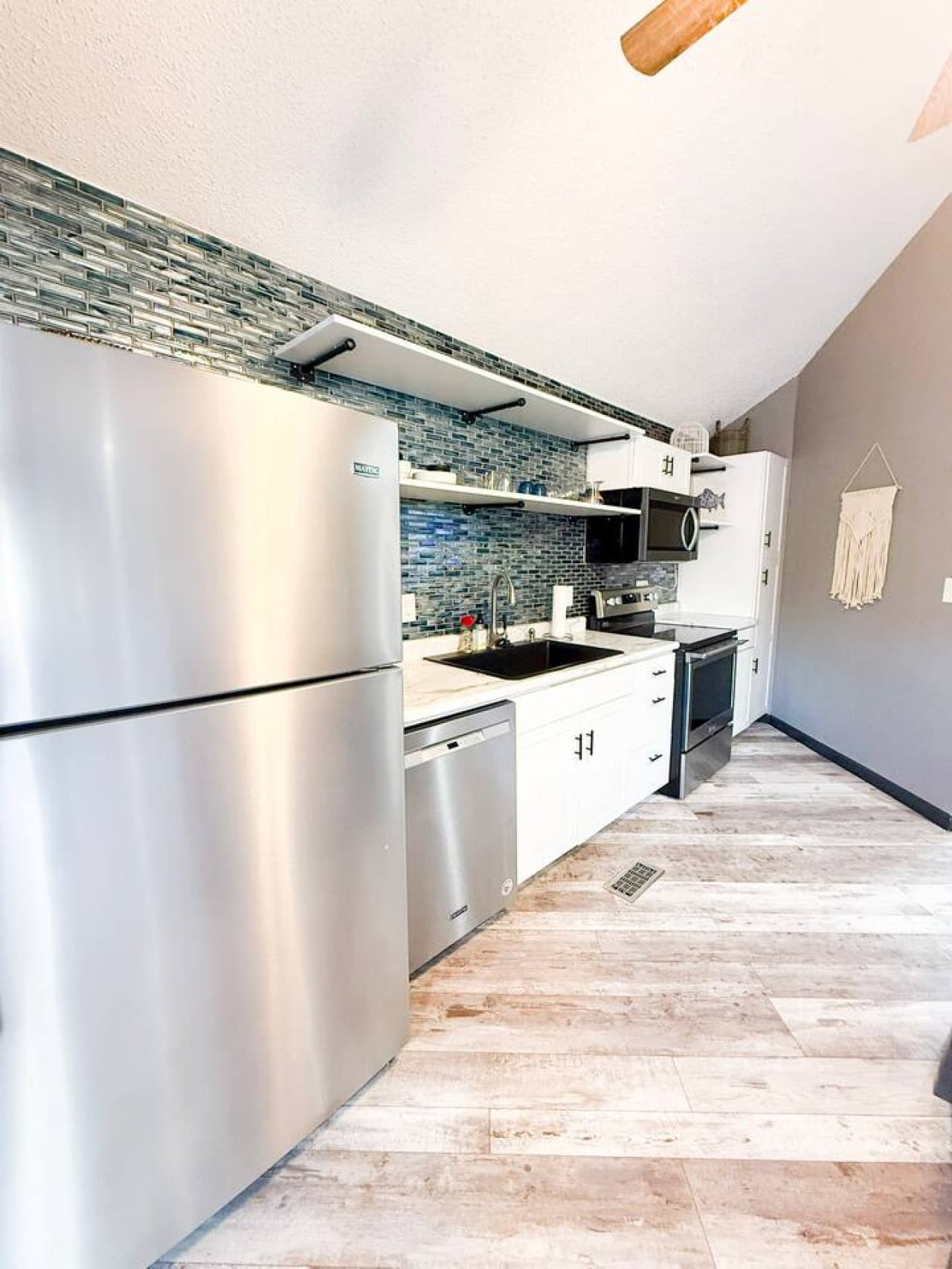 Modern kitchen with stainless steel appliances and sleek design.
