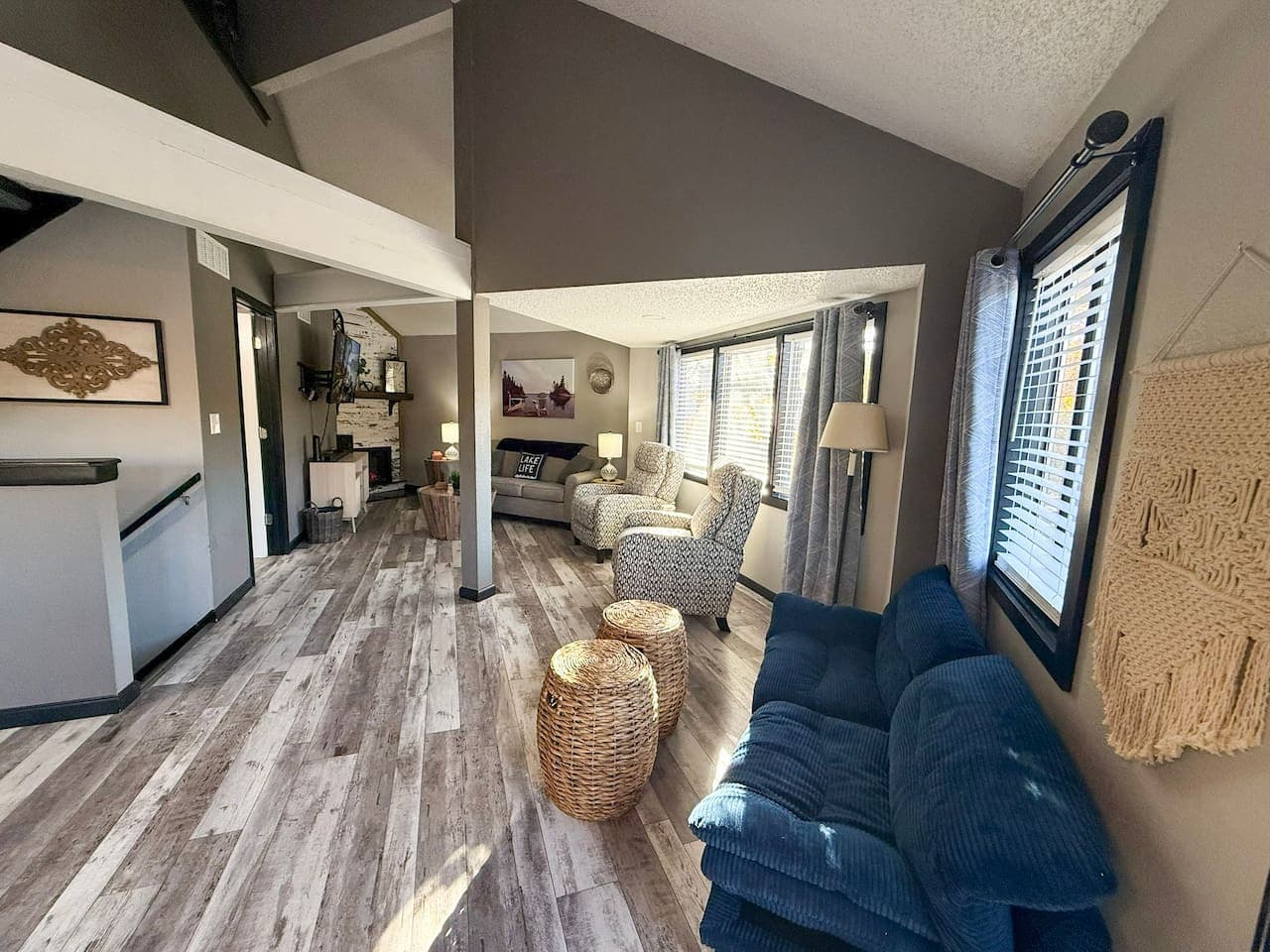 Open floor plan with large windows and inviting furnishings.