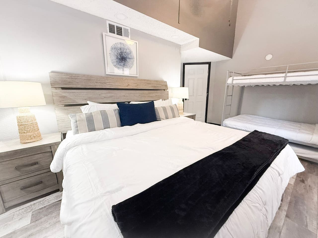 Spacious bedroom with a king bed and bunk beds — perfect for families.