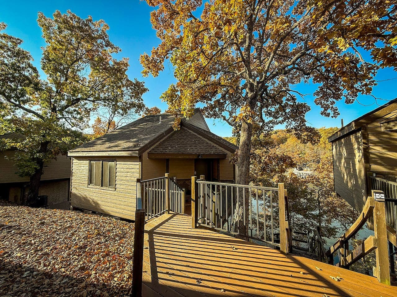 Charming lakeside cabin surrounded by beautiful trees.