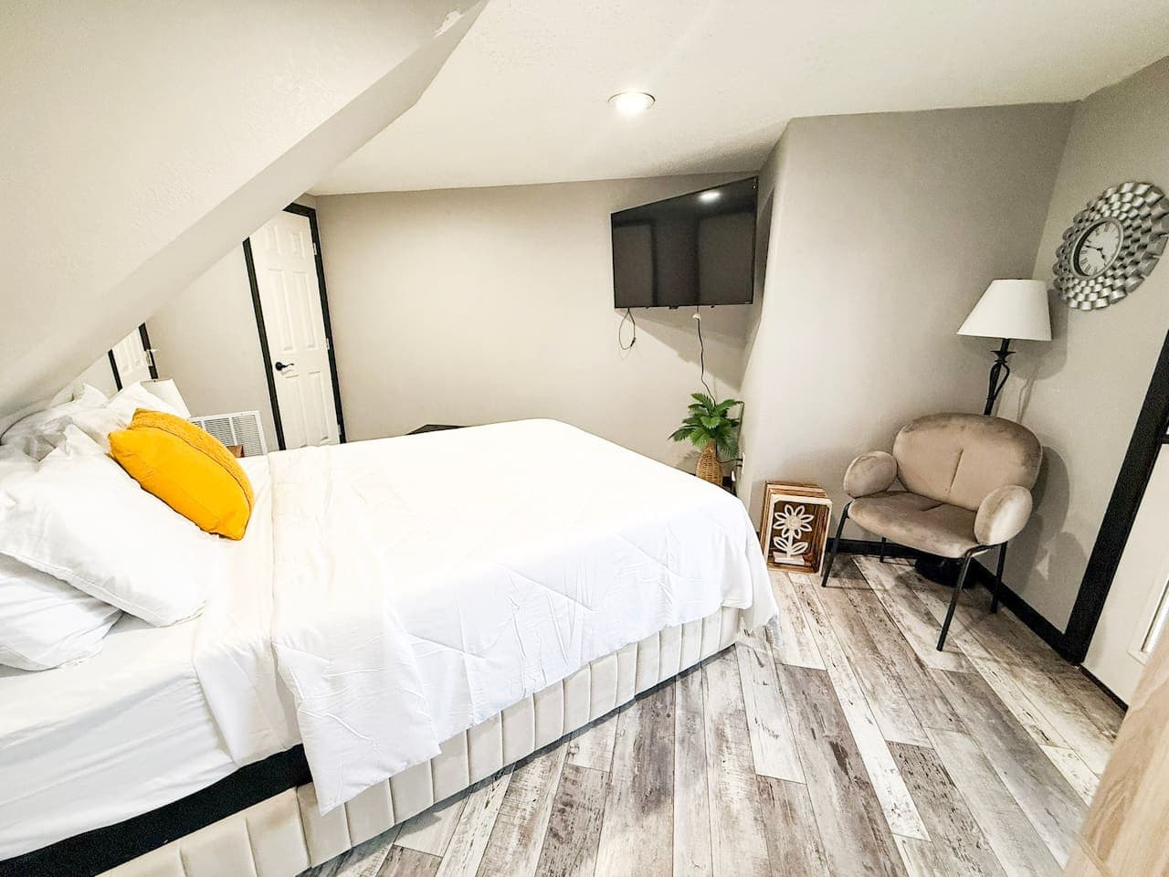 Cozy bedroom with TV and modern touches.