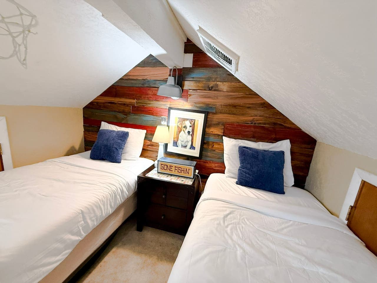This inviting loft bedroom offers two comfy twin beds and a colorful rustic backdrop that feels instantly relaxing. Ideal for families or groups looking for a unique and cozy stay.