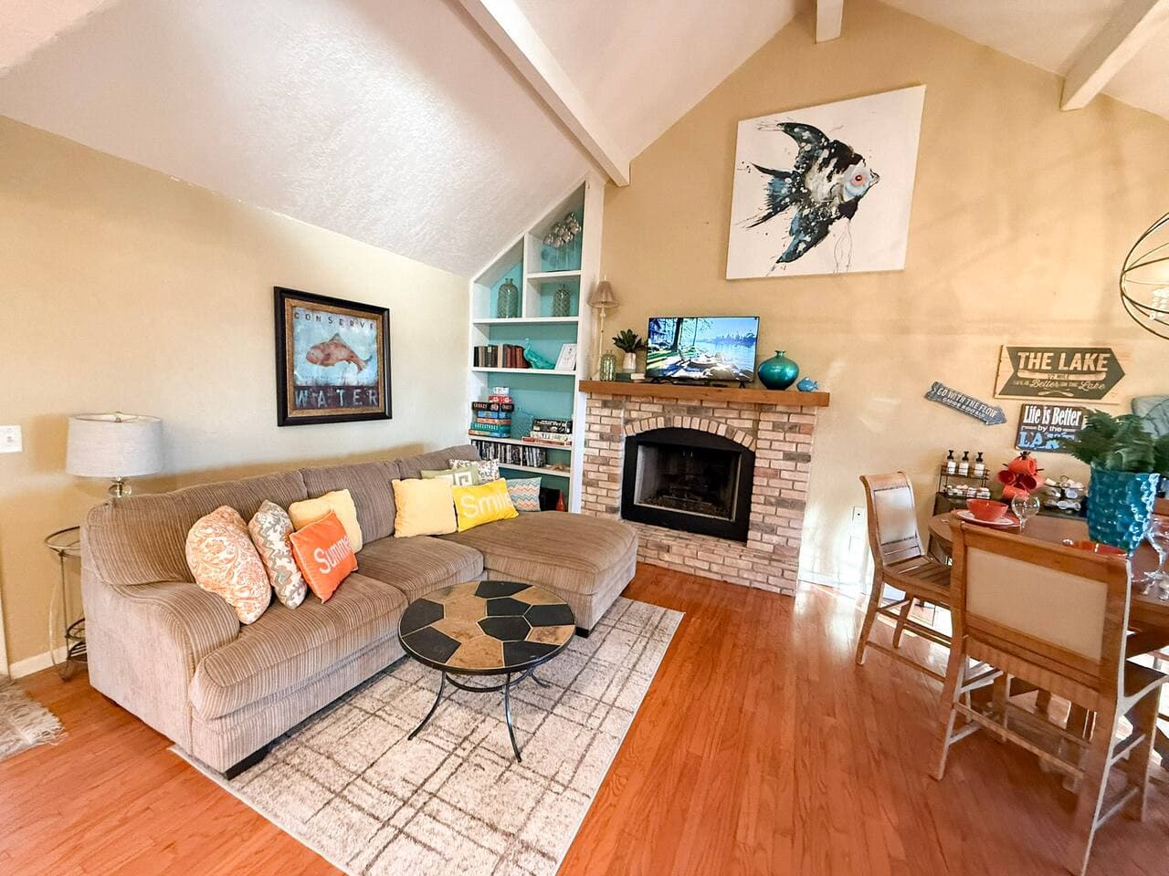 Enjoy a cheerful, sunlit living room with modern décor, built-in shelving, and plenty of cozy seating. A guest favorite for movie nights, lounging, and creating memorable moments.