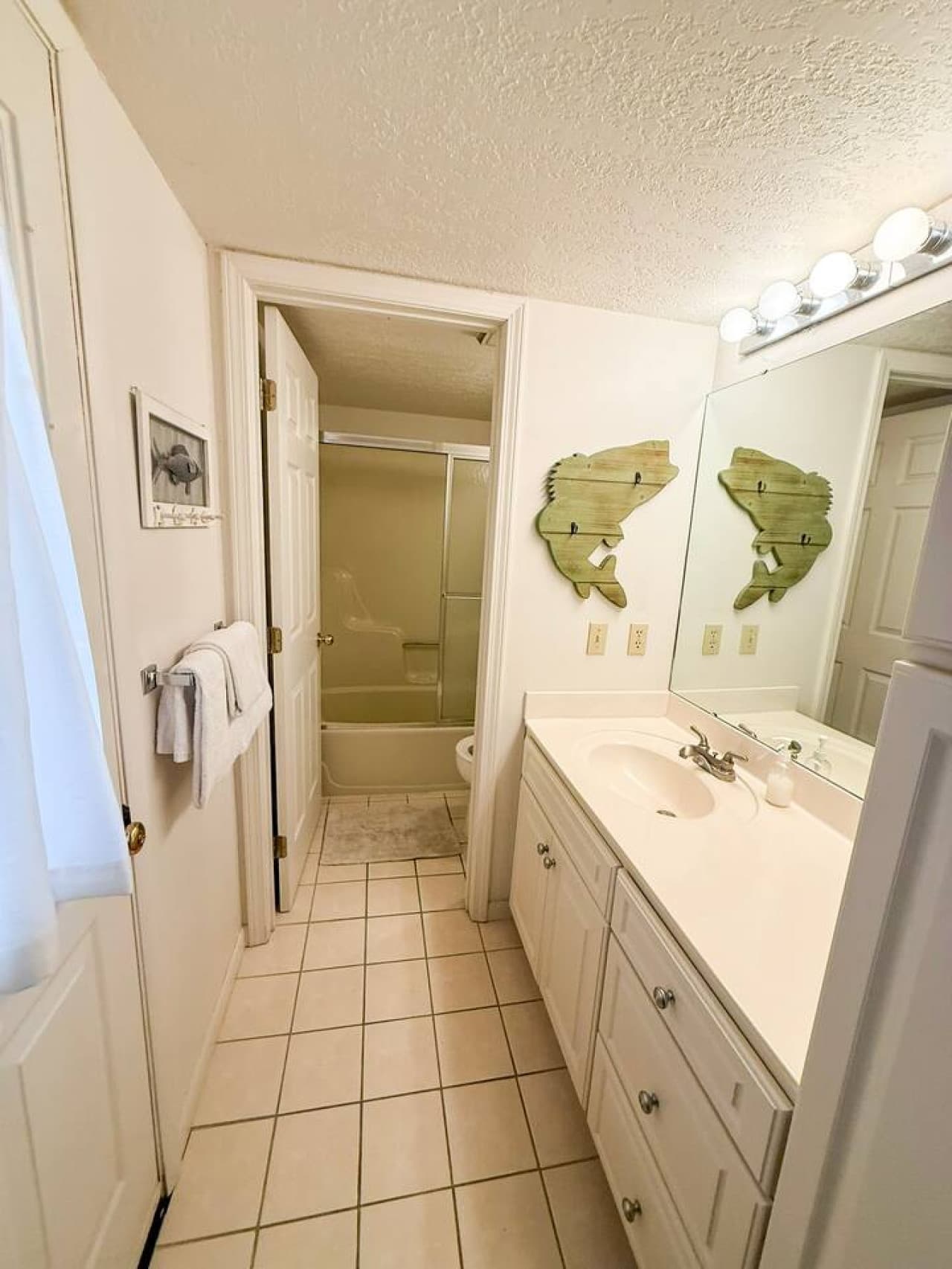 Enjoy a bright, spacious bathroom with a large vanity, full tub/shower, and fresh linens ready for your stay. Perfect for guests who value cleanliness, comfort, and convenience