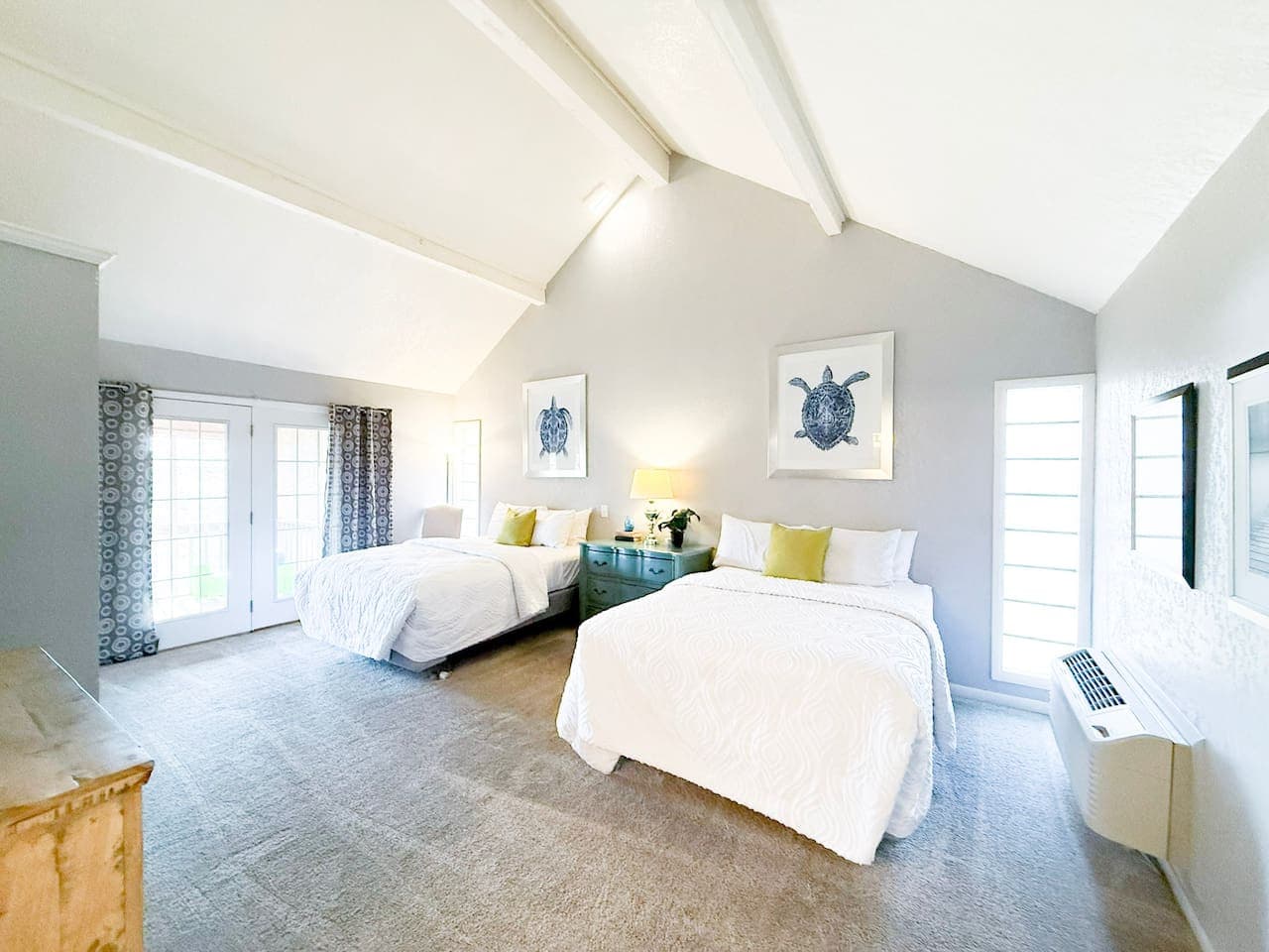 This spacious, sun-filled bedroom offers two cozy beds, elegant décor, and direct access to outdoor views. Ideal for guests wanting a calm, comfortable, and beautifully designed stay.