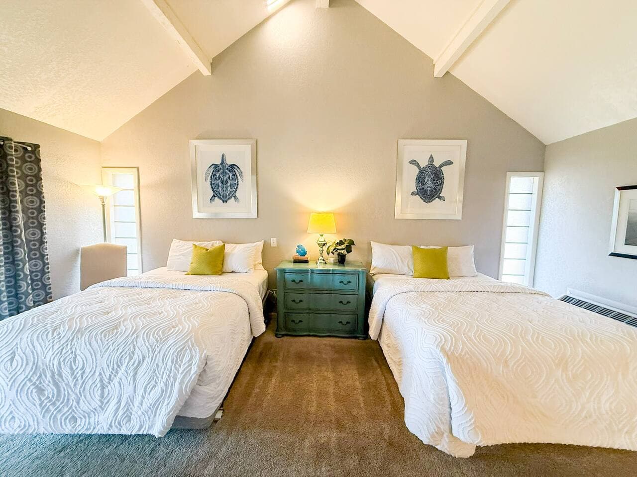 Modern coastal charm meets comfort in this bright double-bed suite with calming artwork and inviting décor.