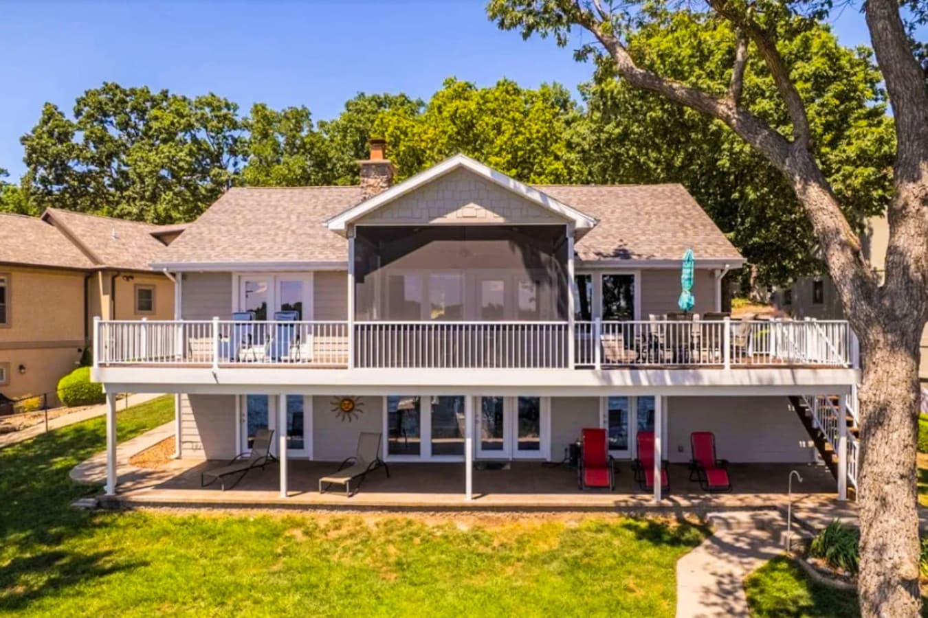 Experience lakeside living at its best in this spacious waterfront home, complete with wide decks, panoramic views, and multiple outdoor lounging areas—perfect for soaking up the sun, relaxing, and making lasting memories