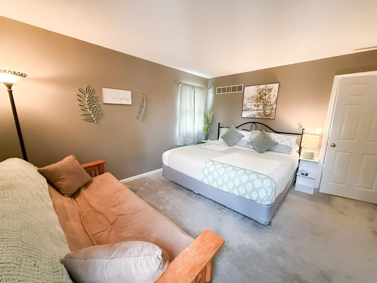 Comfortable bedroom with king bed and futon seating.
