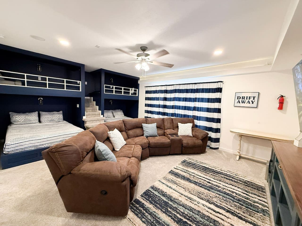 Cozy bunk room with spacious sectional—perfect for movie nights.
