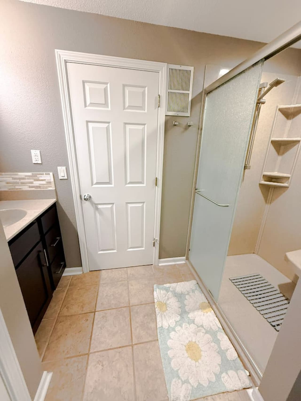 Bright bathroom with large vanity and glass shower.