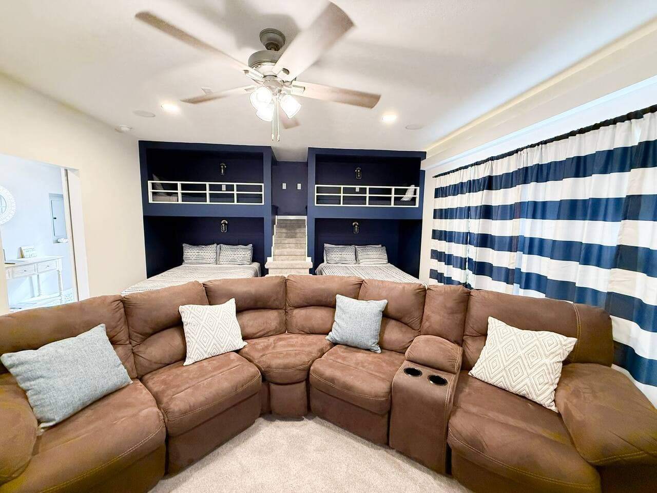 Bunk room with comfy built-ins and a large sectional for lounging.