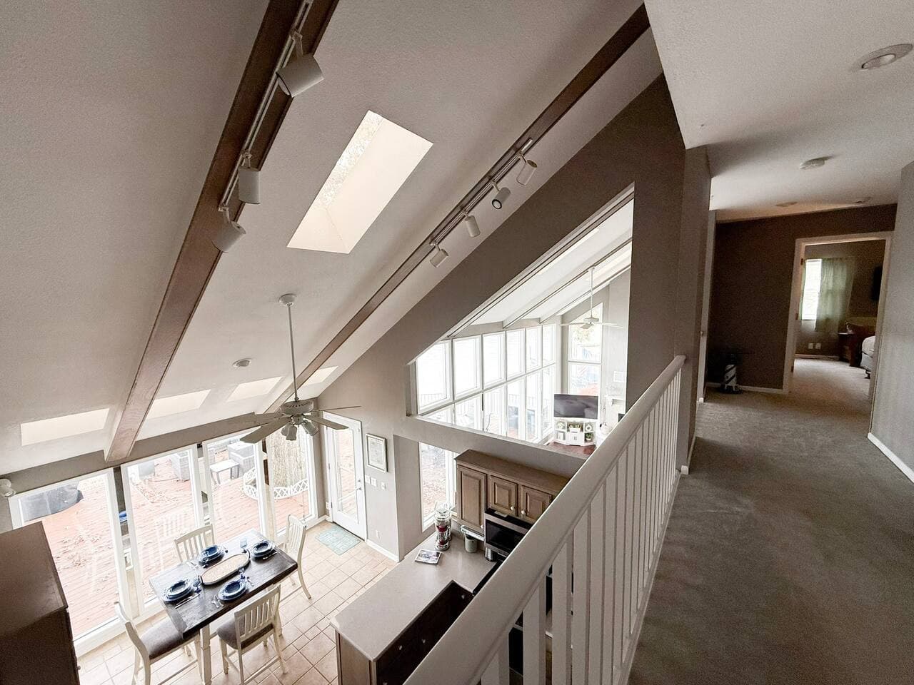 Bright loft view overlooking the open living and dining areas.