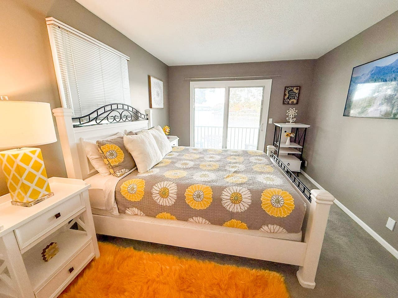 Inviting bedroom with balcony access and vibrant décor.
