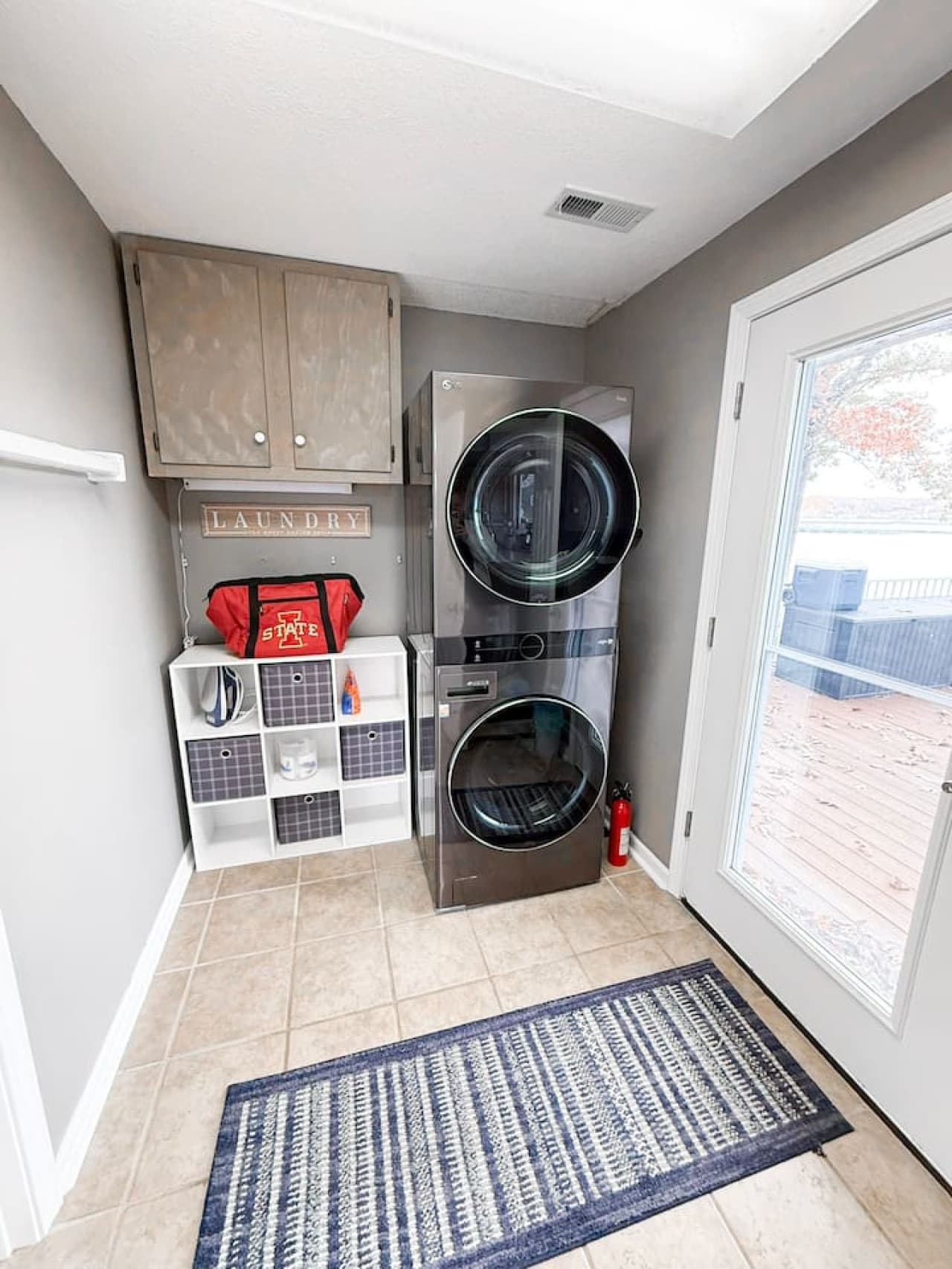 Convenient laundry area with modern washer/dryer and storage.