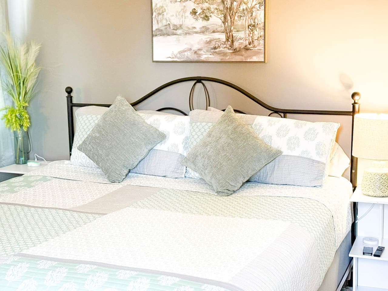 Plush king bed with soft pillows and calming décor.
