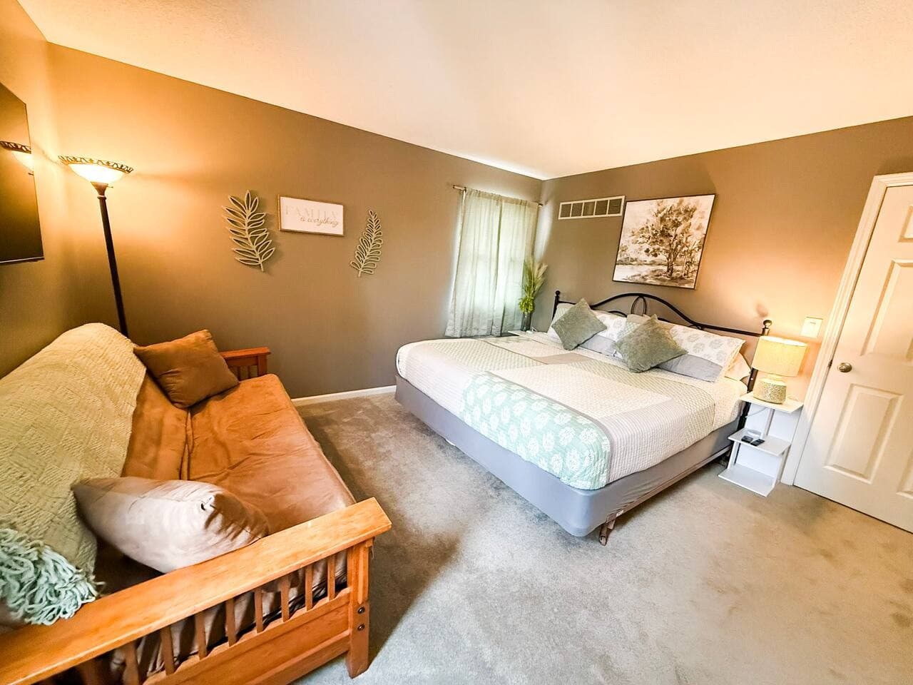 Comfortable bedroom with king bed and futon for extra seating or sleeping.