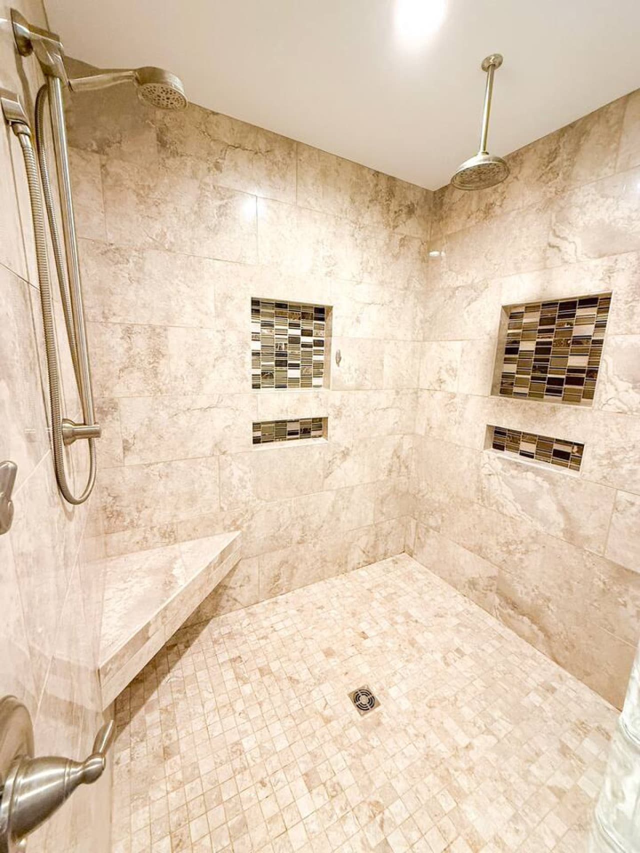 Luxurious walk-in shower with custom tile.