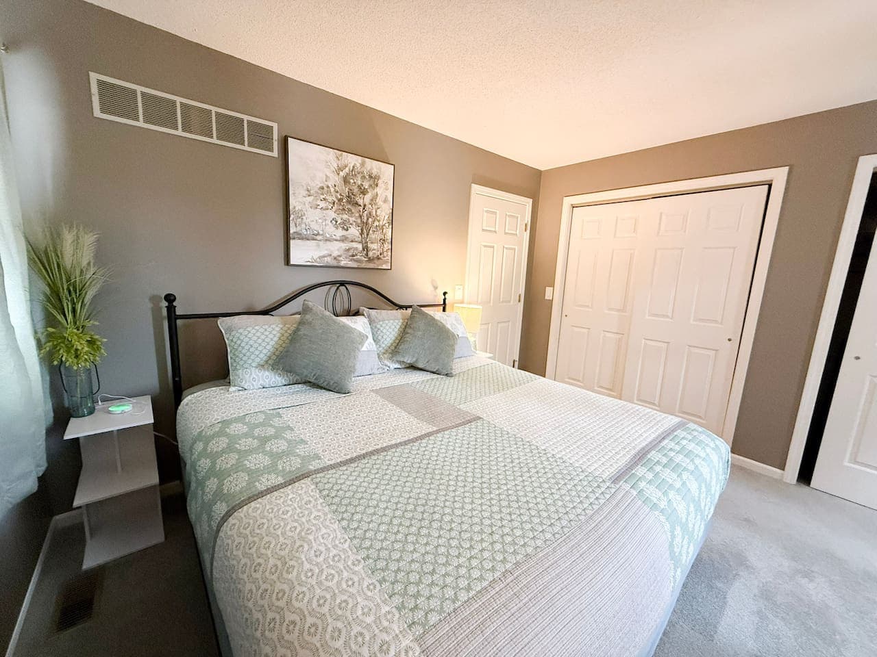 Inviting bedroom with soft tones and a king bed.