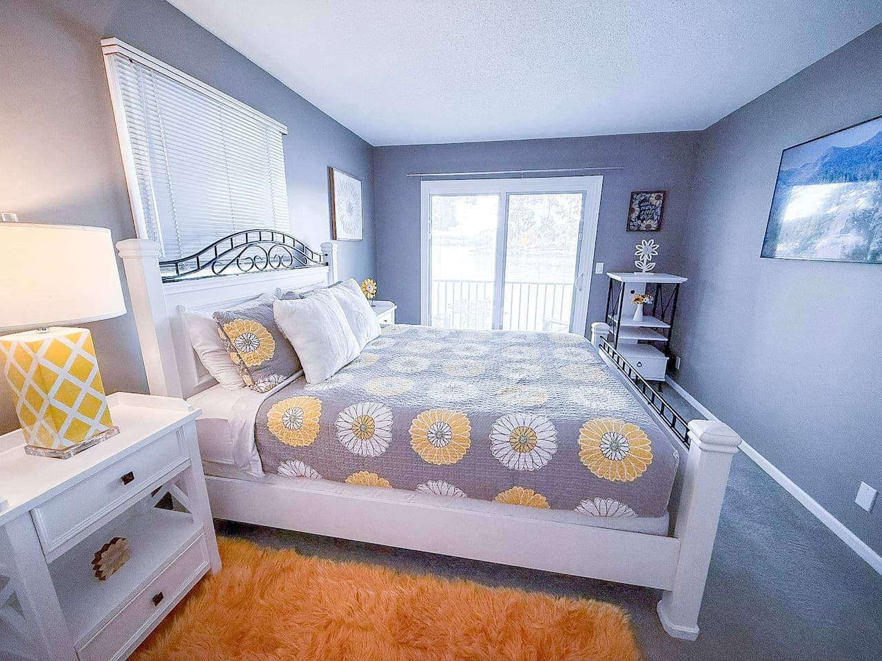 Bright bedroom with balcony access and cheerful bedding.