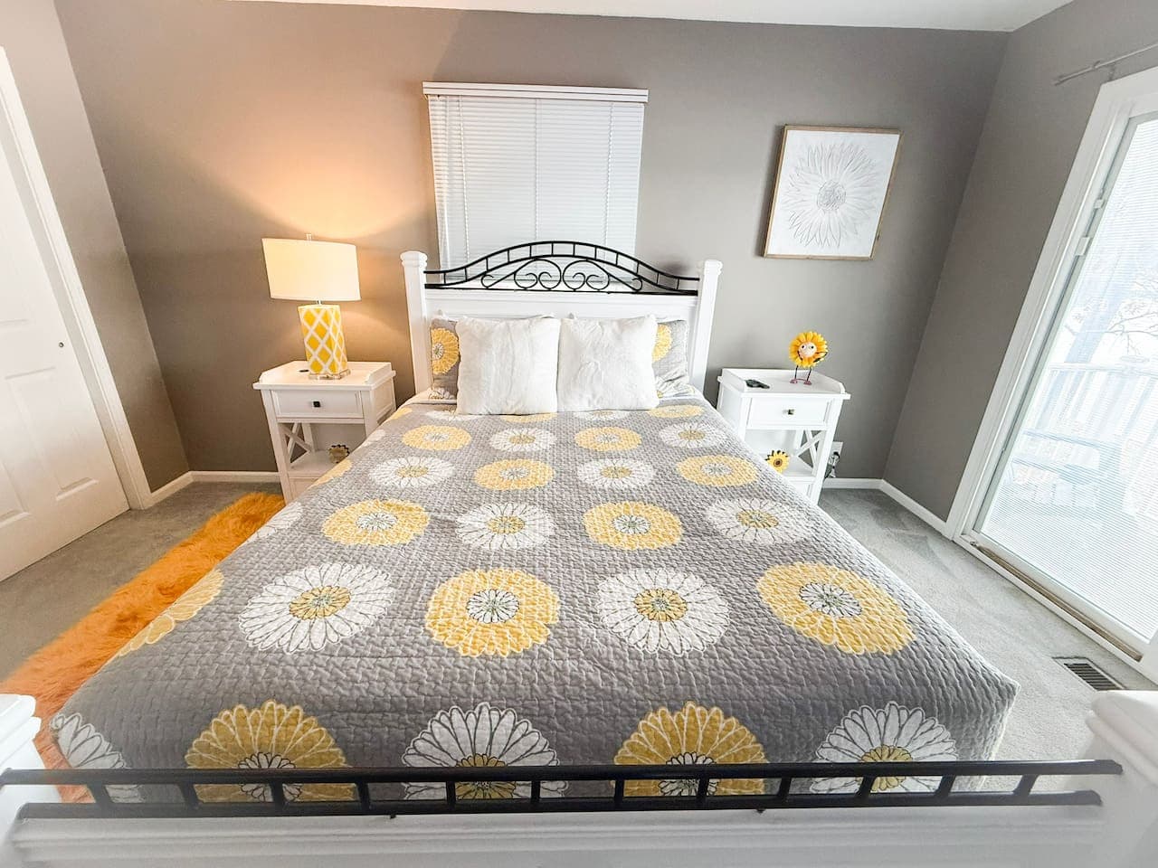 Cozy bedroom with bright yellow and gray decor.