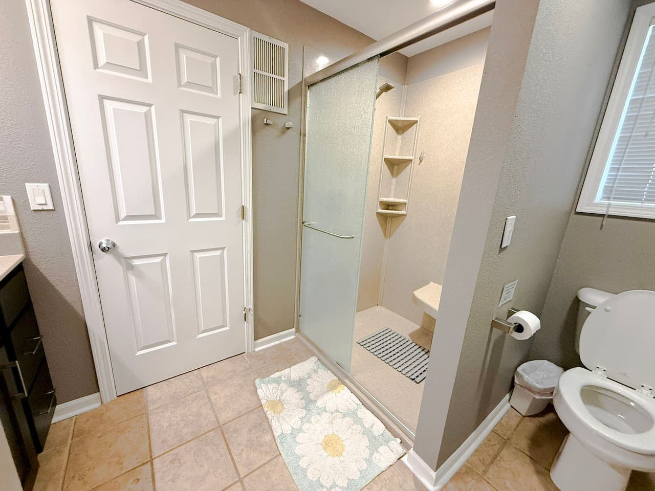 Clean bathroom with a convenient walk-in shower.