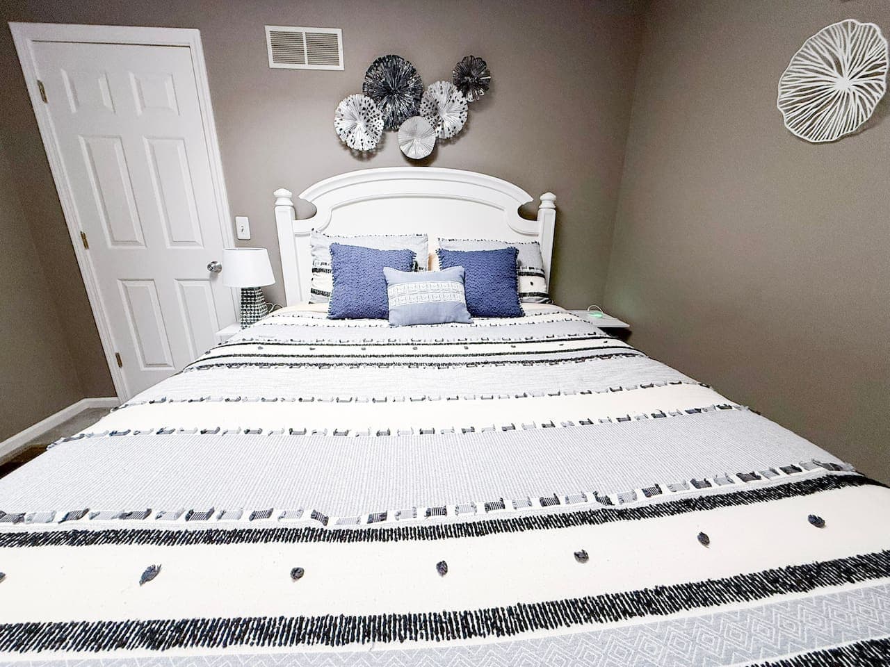Inviting guest bedroom with a comfortable bed and soothing blue accents.