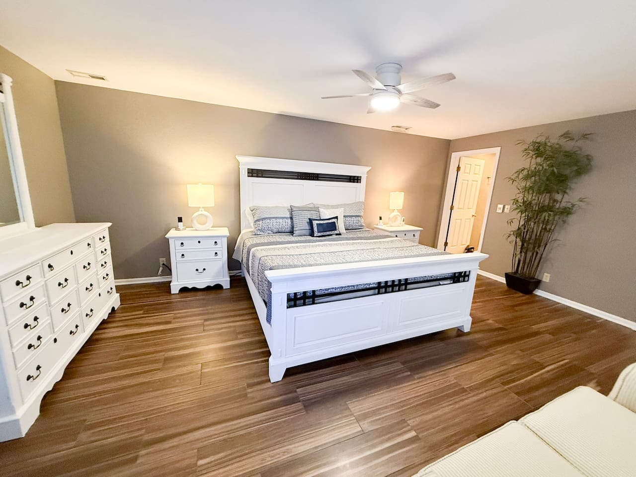 Serene master bedroom featuring a comfortable white bed and stylish decor.