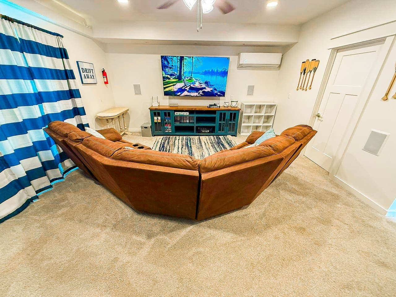 Relaxing living area with a large sectional sofa and big screen TV.
