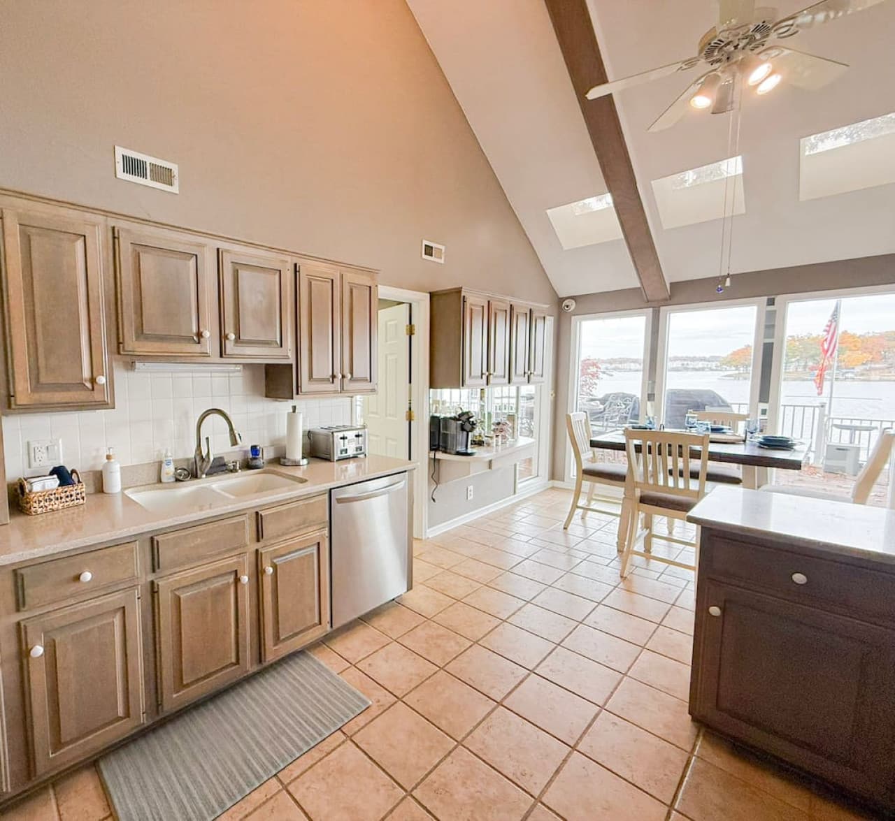 Bright kitchen with all essentials and a dining area overlooking the water.