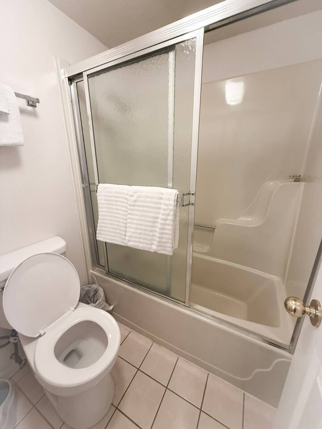 Refresh and recharge in a clean, spacious bathroom with a walk-in shower and fresh towels.