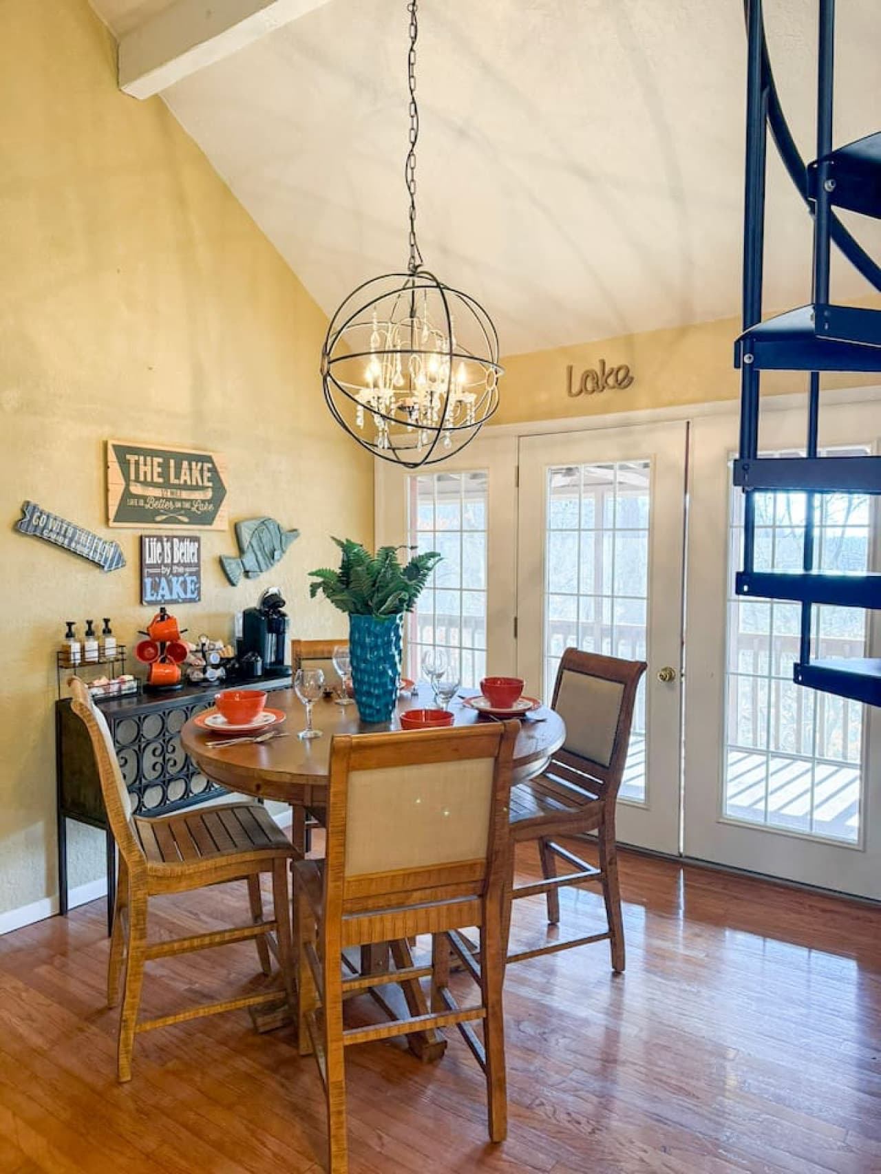 Gather for meals in a bright, lake-inspired dining space with stylish décor and plenty of natural light.