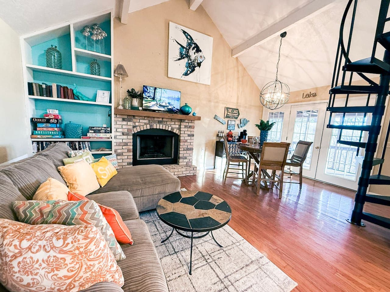 Unwind in a spacious, open-concept living area with cozy seating, stylish décor, and a warm fireplace.