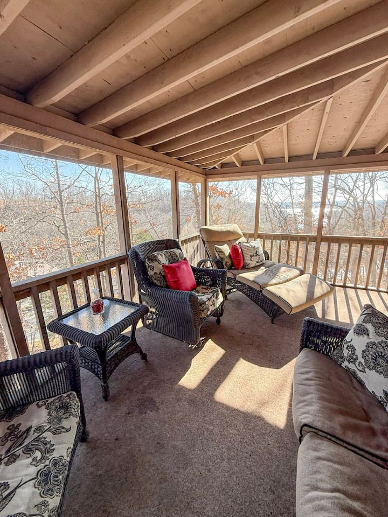 Relax on the private screened-in porch with cozy seating and peaceful wooded views—perfect for morning coffee or sunset chats.