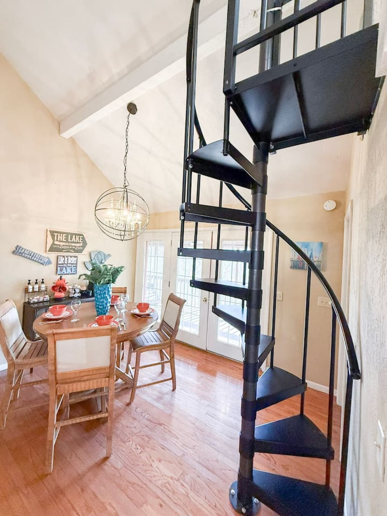 Enjoy a bright, open dining space with lake-inspired décor and a unique spiral staircase centerpiece.