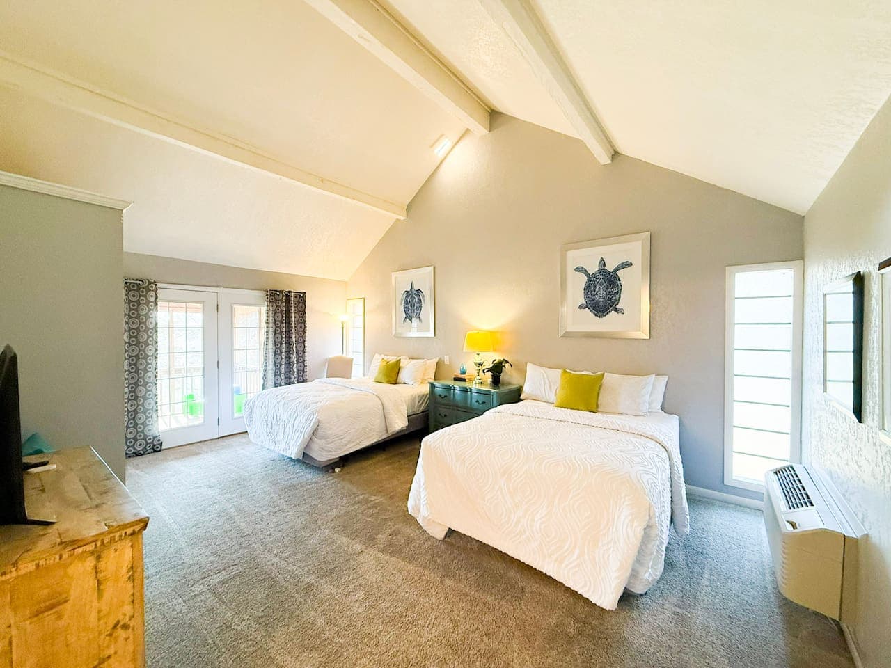 Relax in a bright, spacious bedroom with plush beds, calming décor, and plenty of natural light.