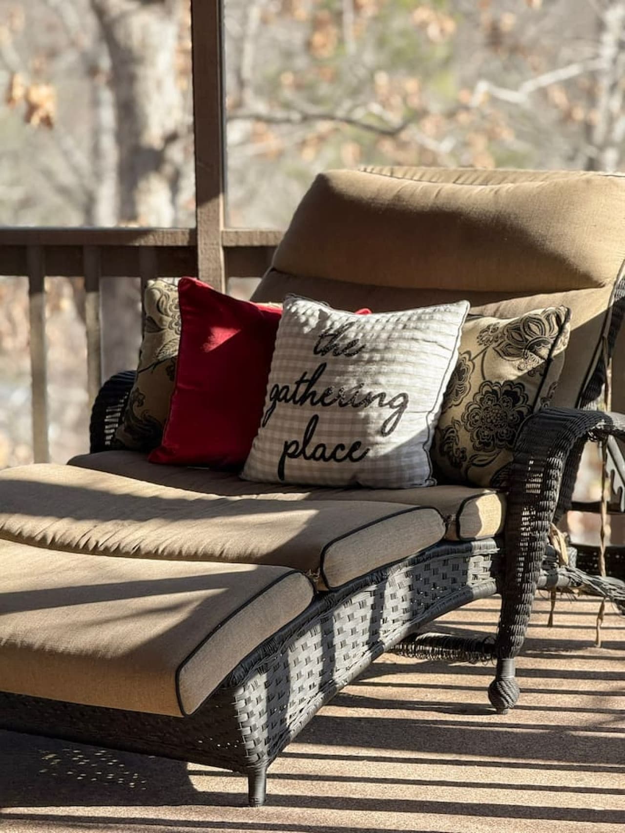 Charming porch lounger with plush cushions creates a cozy retreat with beautiful outdoor scenery.