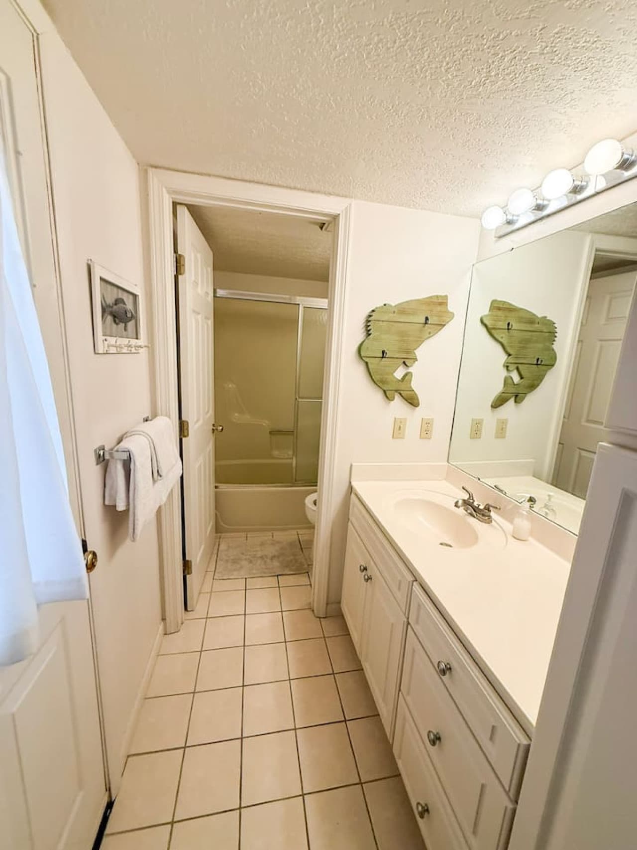 Enjoy a bright, spacious bathroom with a large vanity, full tub/shower, and fresh linens ready for your stay. Perfect for guests who value cleanliness, comfort, and convenience