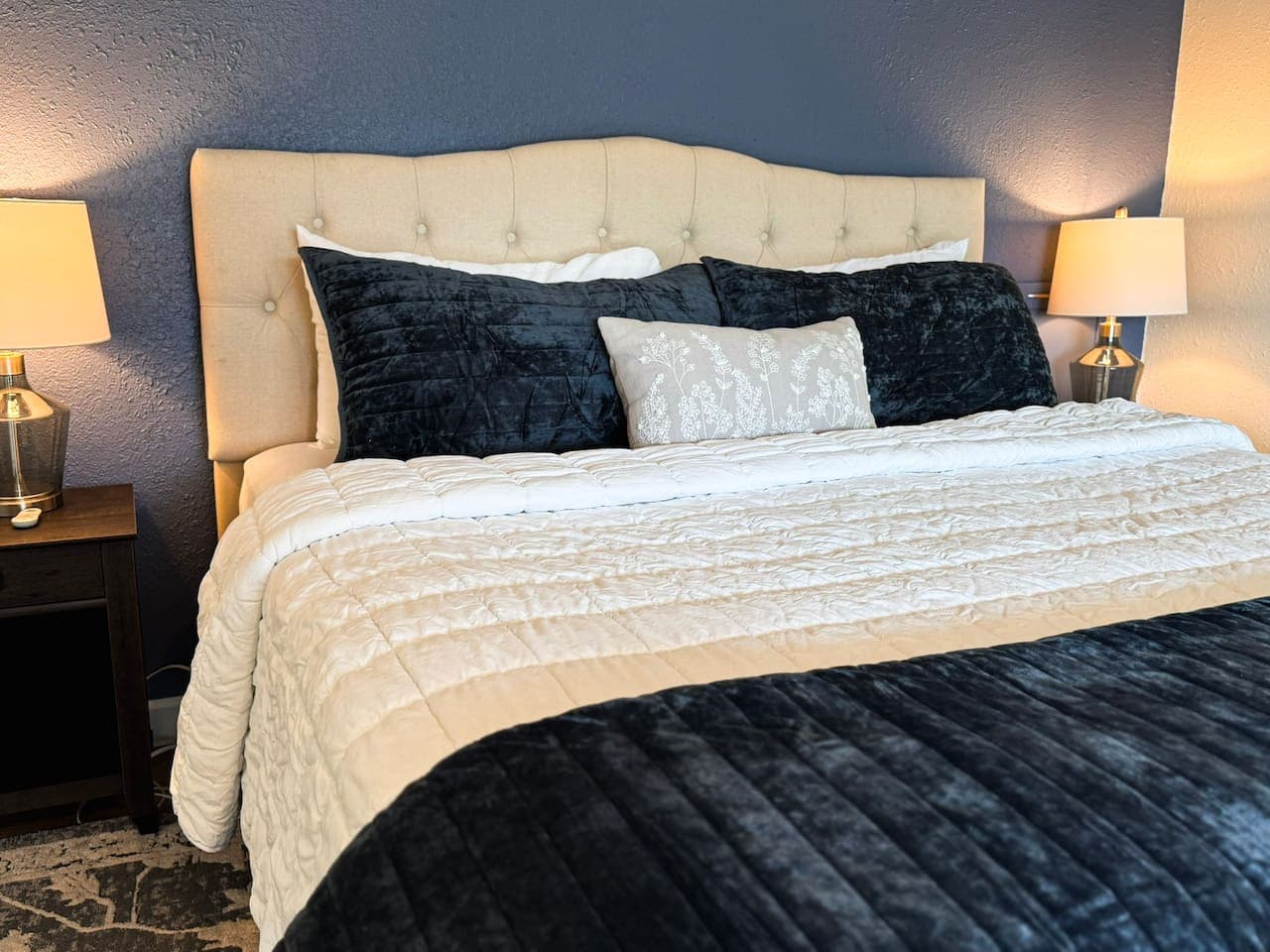Unwind in a luxurious king bed with plush bedding, designed for deep rest and total comfort.