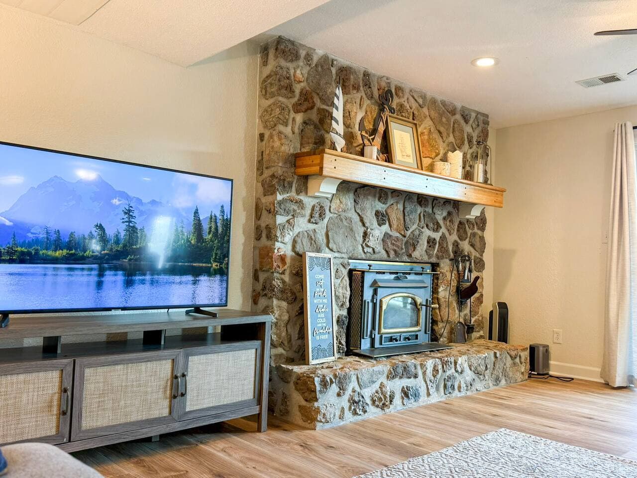 Gather and relax in the cozy living room with a stone fireplace, perfect for unwinding after a day on the lake.