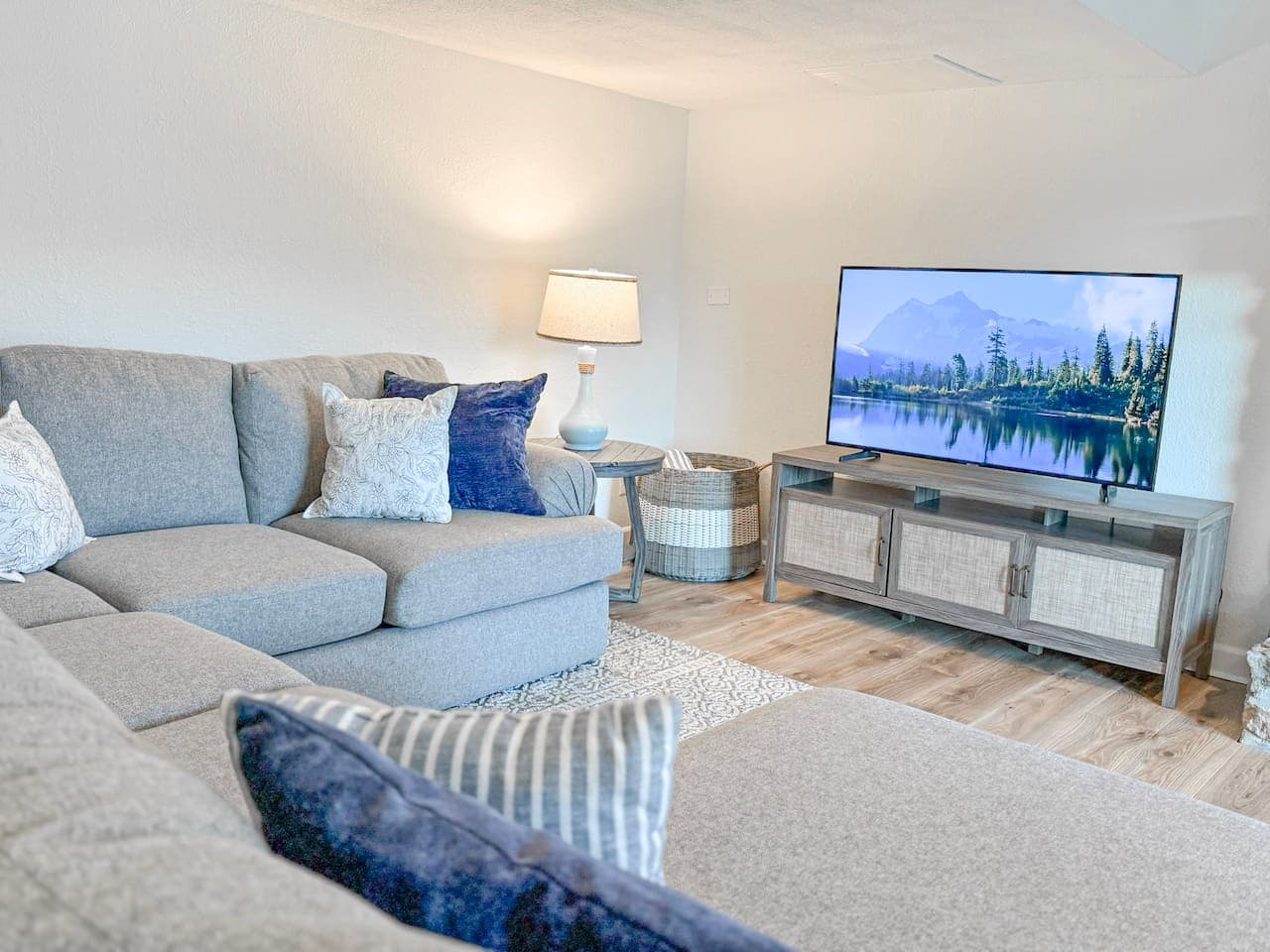 Relax in this bright, cozy living room with plush seating and a smart TV, perfect for unwinding after a day on the lake.