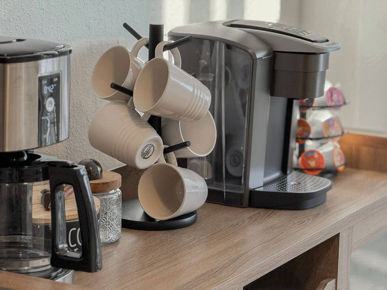 Start your mornings right with a dedicated coffee station, complete with a Keurig and cozy mugs ready to use.