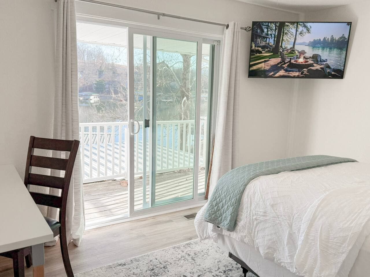 Wake up in a cozy lake-view bedroom with direct deck access, perfect for morning coffee and fresh air.