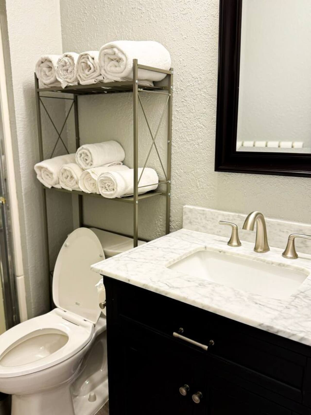 Refresh and recharge in this clean, modern bathroom with plush towels and spa-style finishe