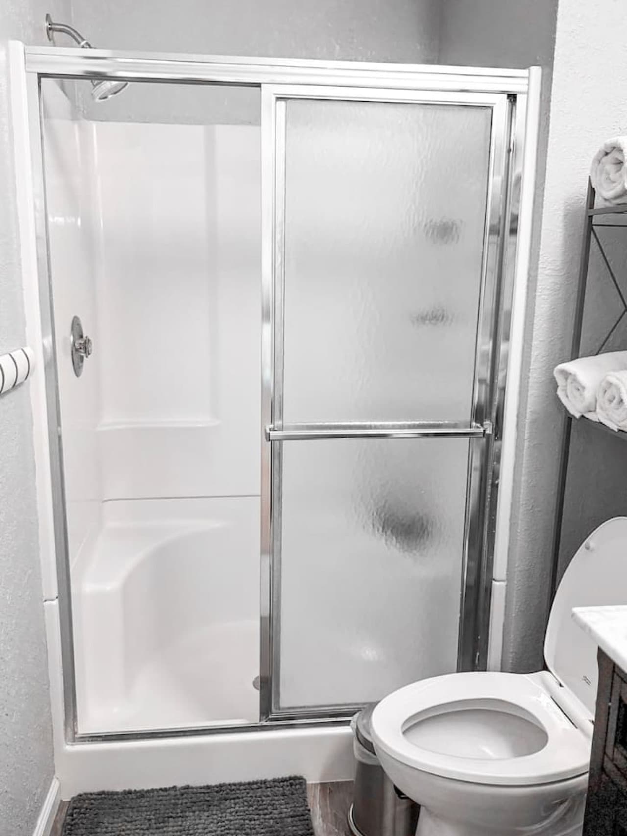 Refresh in a clean, modern bathroom with a spacious walk-in shower designed for comfort and convenience.