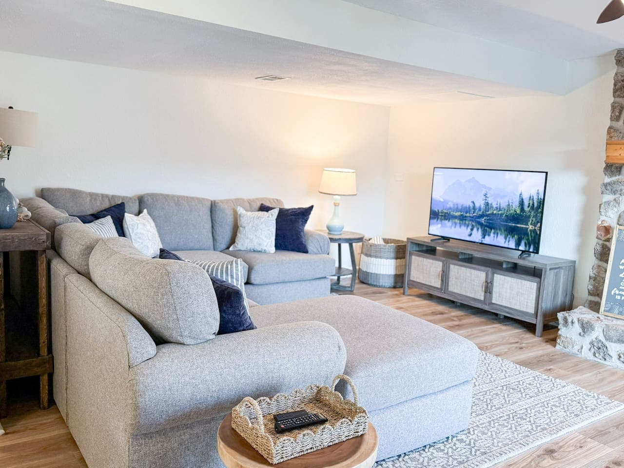 Relax in the spacious living area with plush seating and a large TV, perfect for unwinding after a day on the lake.