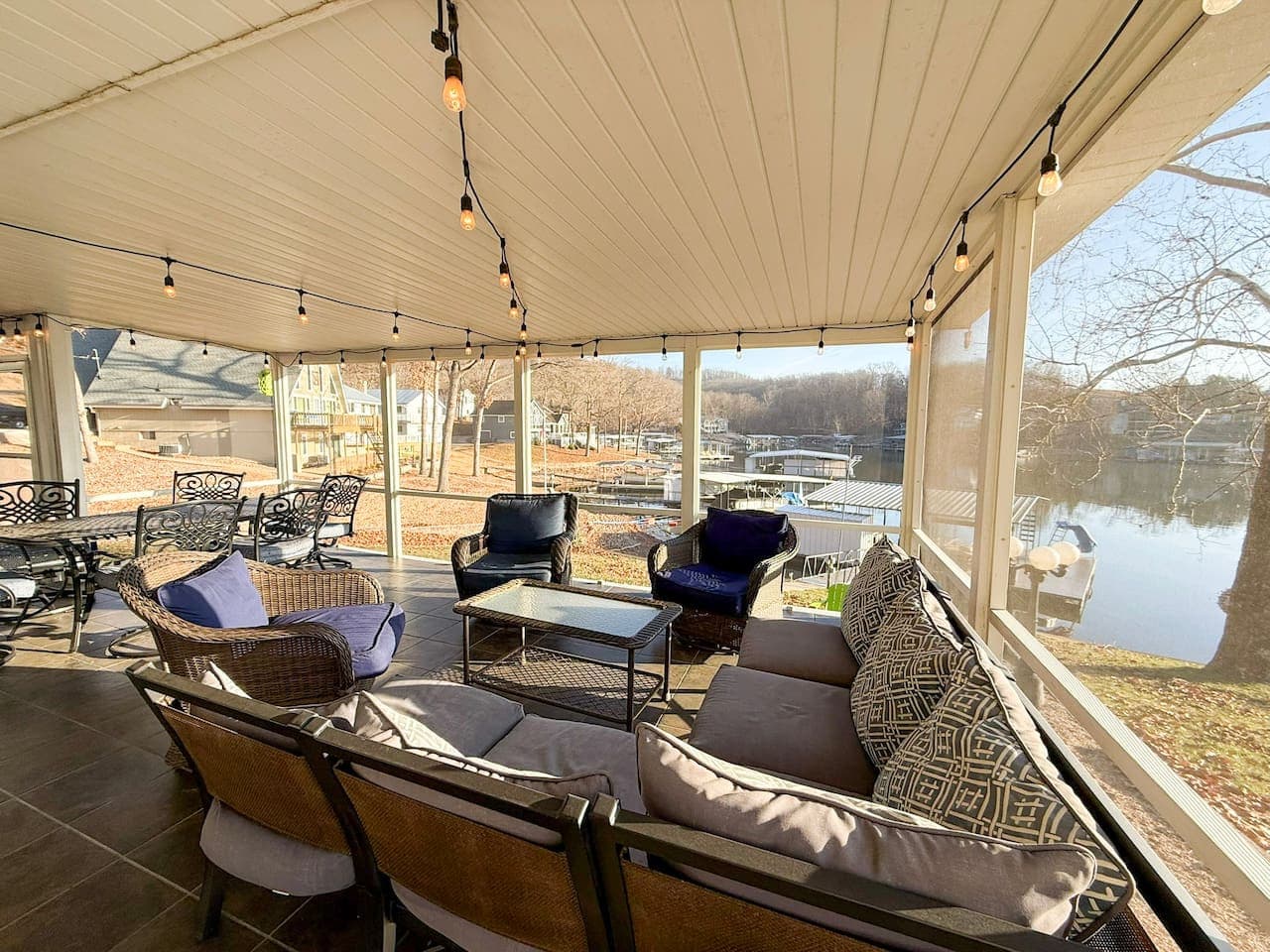 Gather and relax in the spacious covered patio with string lights and lake views, perfect for entertaining or unwinding.