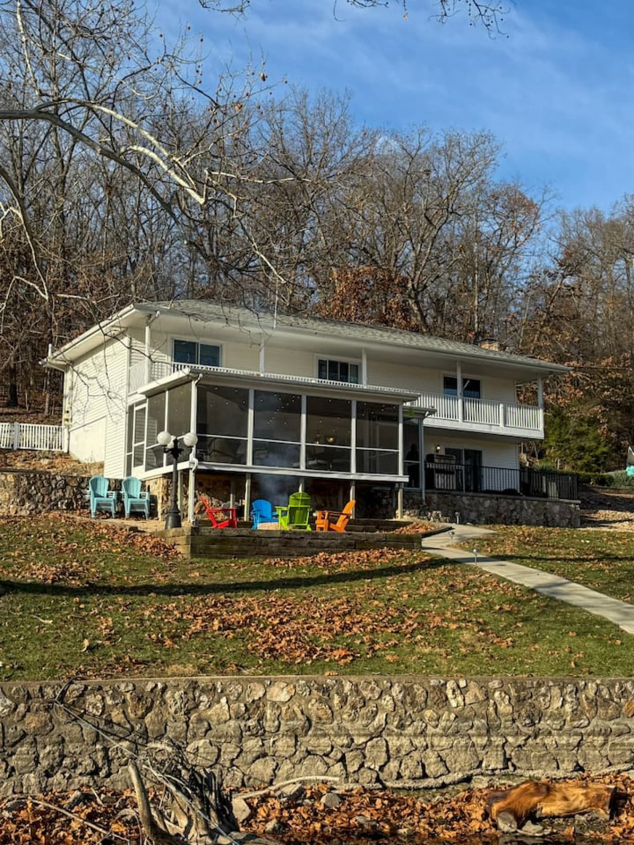 Stay at this charming lakefront home with expansive decks and peaceful water views, surrounded by nature.
